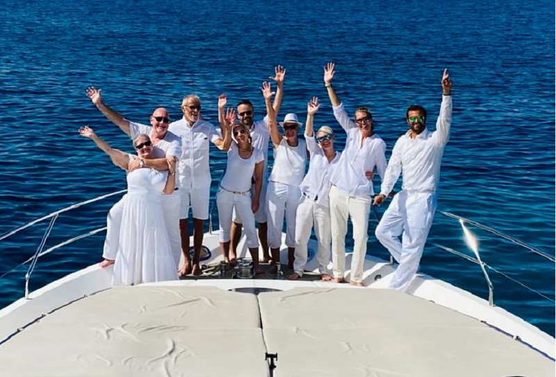 group dressed in white on charter yacht