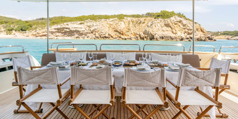 Dolce-Vita-II-Astondoa-102-luxury-yacht-charter-Balearics-Exterior-dining-table-10pax