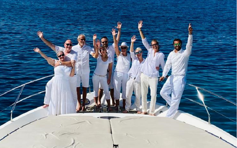 group dressed in white on charter yacht